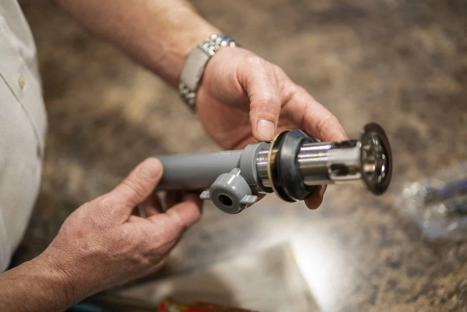 Sandy, UT Plumber evaluates valve for plumbing installation in Sandy