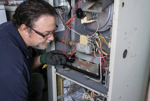 Manwill technician repairs furnace in Salt Lake City