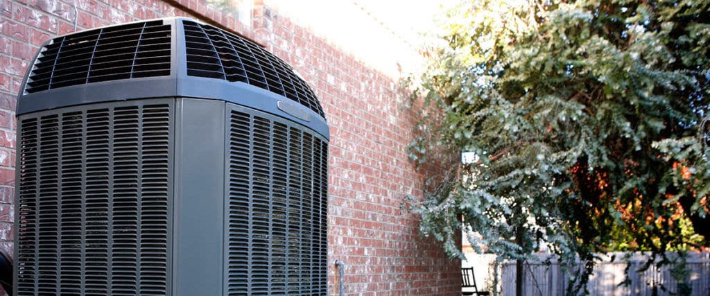 Air conditioner unit outside of brick home in Utah