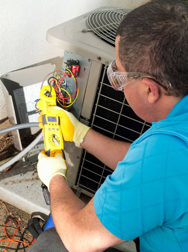 Manwill AC technician repairs air conditioning unit