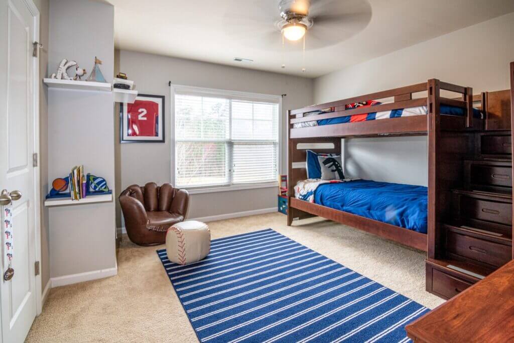 ceiling fan in bedroom with bunk beds and baseball chair