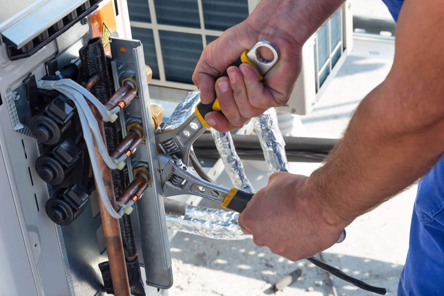 Man repairs air conditioner in Alpine Utah