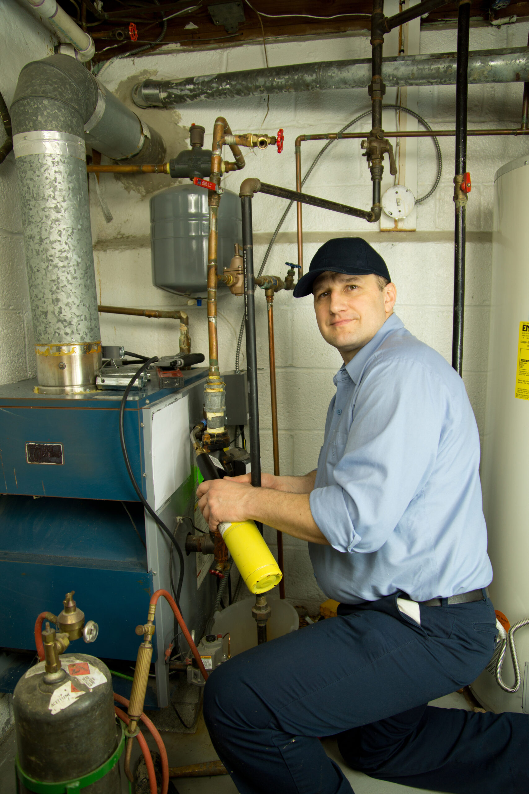 HVAC professional making repairs to a furnace in a Taylorsville home