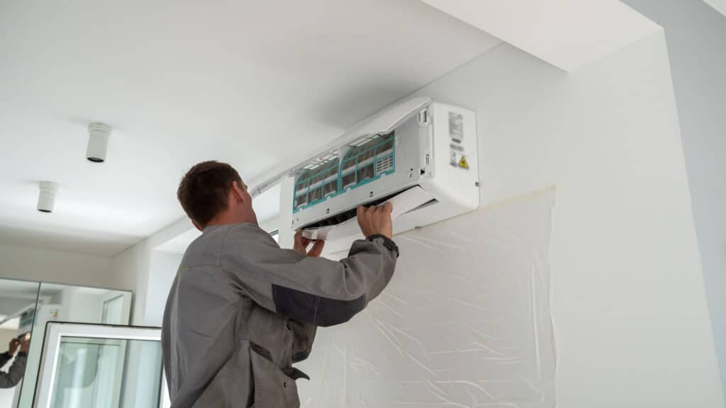 An HVAC contractor installing a ductless mini split system in Utah