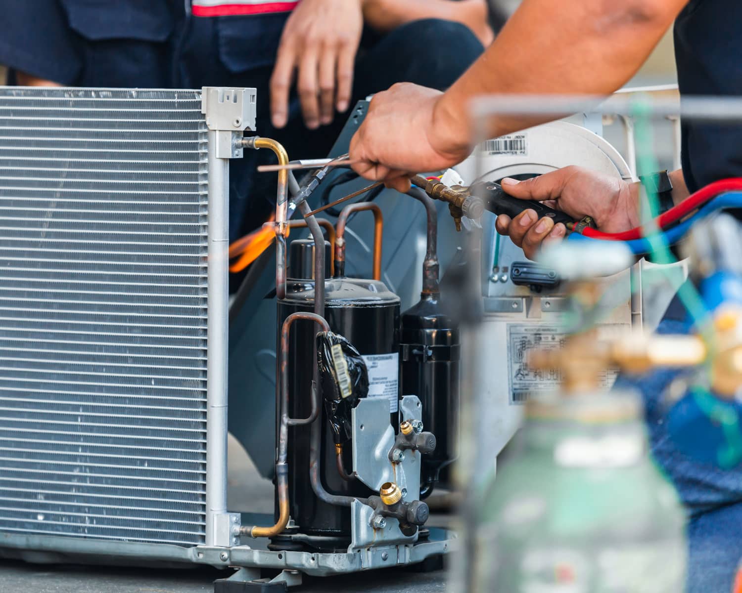 Service techs from Manwill completing maintenance on an AC component.