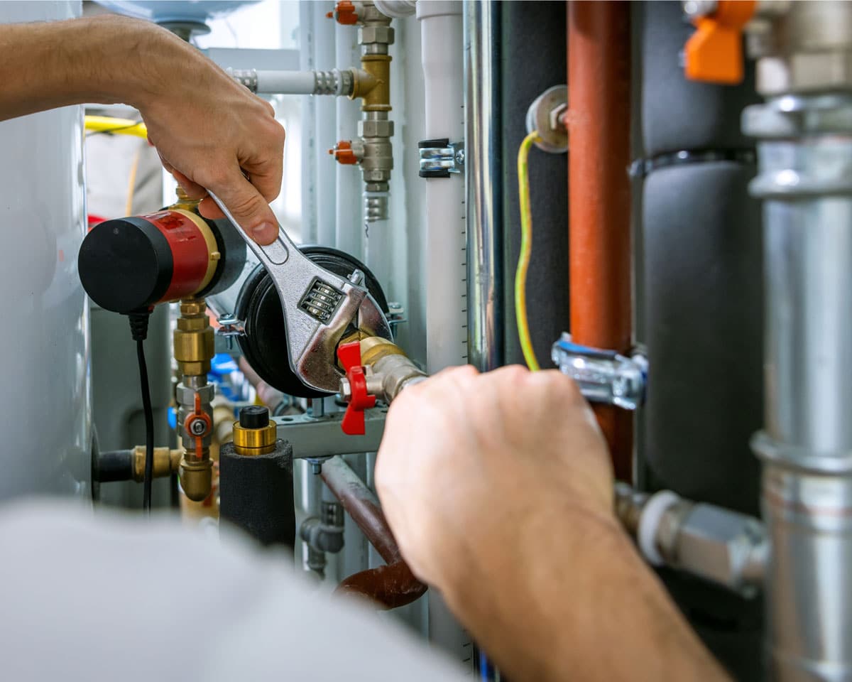 Manwill technician working on plumbing pipes for Grantsville HVAC and plumbing services