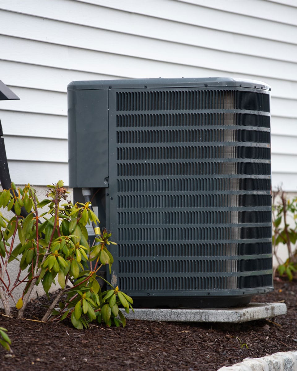 Residential air-conditioning condenser installed outside a home